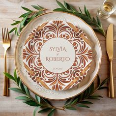 a plate with a name on it sitting next to silverware and gold cutlery