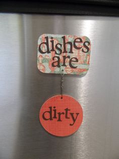 there is a sign on the refrigerator saying dishes are dirty