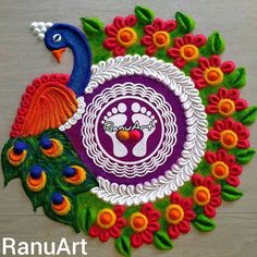 a peacock with colorful feathers and flowers on it's back side is featured in this rang art project