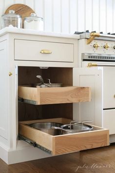 an open drawer in the middle of a kitchen