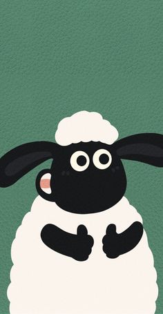 a black and white sheep standing on top of a green field with its eyes wide open