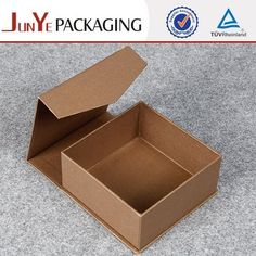 an open cardboard box sitting on the ground with its lid open and it is empty