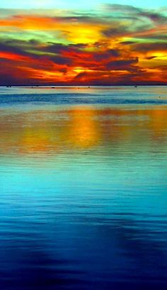 an orange and blue sunset over the ocean