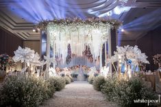 an elaborate wedding setup with flowers and chandeliers