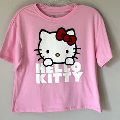 Adorable Medium Pink Color Cropped Hello Kitty Tee Shirt Is Lightweight Made From A Cotton Polyester Blend. New With Tags. Size Medium. Measurements Laying Flat Are Approximate (See Photos): Armpit To Armpit - 17” Length- 20” Cropped Length Hello Kitty Short Sleeve Top, Hello Kitty Crew Neck Fun Tops, Hello Kitty Fun Crew Neck Top, Hello Kitty Print Y2k Crew Neck Top, Y2k Hello Kitty Print Crew Neck Top, Trendy Pink Hello Kitty T-shirt, Cotton Hello Kitty Fun Tops, Fun Cotton Tops With Hello Kitty, Fun Hello Kitty Short Sleeve Tops