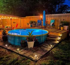 an above ground swimming pool with lights around it