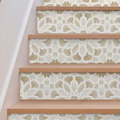 the stairs are decorated with intricate designs and wood treads, along with carpeted flooring