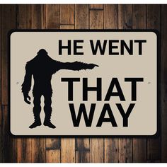 a sign that says he went that way with a bigfoot pointing at the viewer