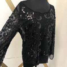 Black Black Top For Winter Party, Black Winter Party Top, Elegant Black Winter Blouse, Black Sequined Tops For Evening, Black Fall Blouse For Night Out, Black Sequined Tops For Spring, Black Blouse For Night Out In Fall, Black Stretch Tops For Evening, Black Stretch Evening Tops