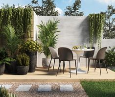 an outdoor dining area with potted plants and chairs