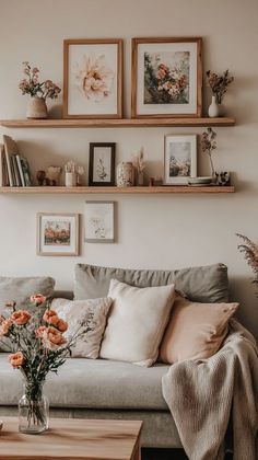 a living room filled with lots of furniture and flowers on top of the couches