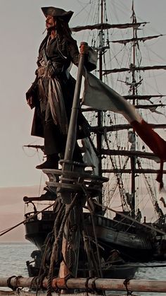 a pirate standing on top of a boat in the water