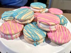 a white plate topped with cookies covered in frosting