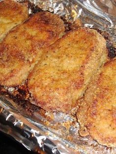 four fried meat patties sitting on top of tin foil