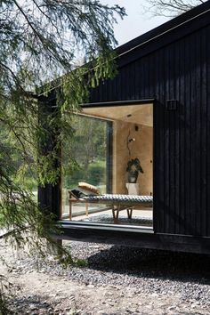 a black cabin with glass walls and sliding doors