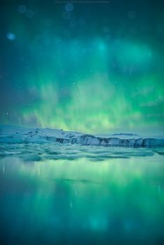 the aurora bore is reflected in the water