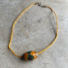 Mustard Yellow Hemp Cord Choker Necklace With A Matching Wooden Bead As A Pendant With Detailed Green, Blue And Red Detailed Painting On It. 13” Long - Message Me To Add An Extension Chain. In Perfect Condition. Casual Yellow Beaded Necklaces With Round Beads, Handmade Yellow Beads For Festival, Yellow Beaded Necklaces For Beach, Casual Yellow Beaded Chain Jewelry, Casual Yellow Beads For Beach, Yellow Wooden Beaded Necklaces For Beach, Yellow Wooden Beads Necklace For Beach, Yellow Necklaces With Wooden Beads For The Beach, Yellow Beach Necklaces With Wooden Beads