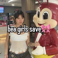 a woman standing next to a statue of a cartoon character with the words bea girls save