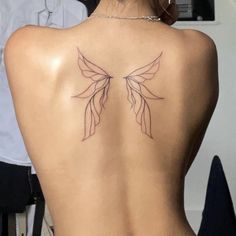 the back of a woman's body with tattoos on her upper and lower back