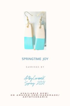 a pair of blue and white earrings with the words springtime joy