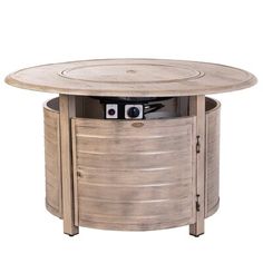 a round table with a camera on top and an open cabinet underneath it that is in the shape of a barrel