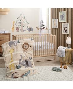 a baby crib bedding set with animals on it