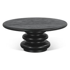 a black table with three stacked rocks on top