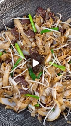 a bowl filled with meat and vegetables on top of a table