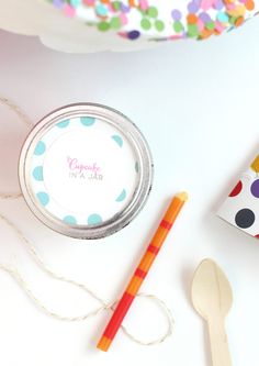 the contents of a birthday party are laid out on a table with confetti and candy