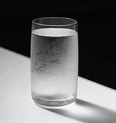 a glass filled with water sitting on top of a table