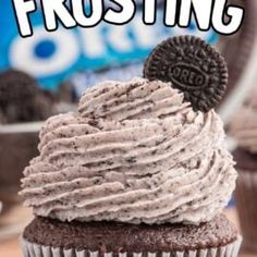 a chocolate cupcake with oreo cookies on top and frosting in the middle