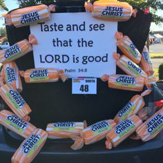 a car with candy wrapped around it and a sign that says, taste and see that the lord is good