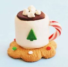 there is a cookie with a cup on it and candy canes in the middle