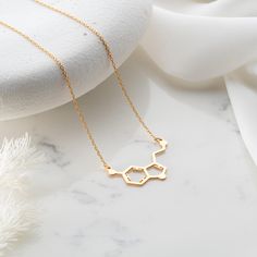 Elevate your style with our Handmade Gold Serotonin Molecule Necklace, a unique and science-inspired accessory that adds a touch of elegance to your look. Meticulously crafted in two exceptional material options: 925 sterling silver and 14K solid gold, this necklace offers a choice between classic sophistication and the enduring warmth of gold. While the choice of materials is significant, what truly sets this necklace apart is the representation of the serotonin molecule, a symbol of well-being and happiness. Whether you opt for the timeless allure of gold or the classic beauty of silver, this necklace is more than jewelry; it's a celebration of the science behind happiness, a subtle yet powerful expression of positivity. Both materials, sterling silver and 14K solid gold, are of the high Serotonin Necklace, Serotonin Molecule, Molecule Necklace, Chemical Structure, Handmade Gold, Minimalist Necklace, Classic Beauty, Elegant Gift, Necklace Etsy