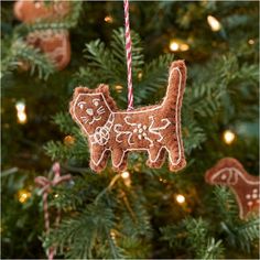 an ornament shaped like a dog hanging from a christmas tree