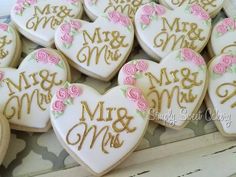 decorated cookies in the shape of hearts with pink roses and mr and mrs written on them