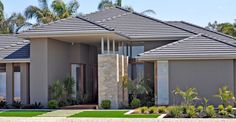 a large house with lots of windows and landscaping