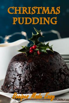 a christmas pudding on a plate with holly decorations