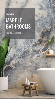 a bathroom with marble walls and flooring next to a white bathtub in front of a plant