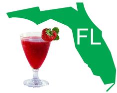 a red drink in a glass with a strawberry on the rim next to a map of florida