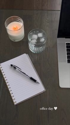 an open laptop computer sitting on top of a desk next to a cup of coffee