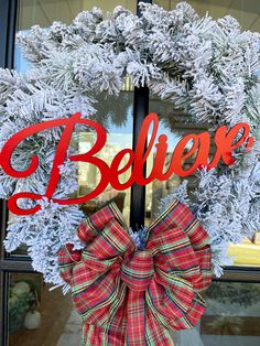 a christmas wreath with the word believe on it