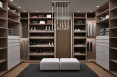 a walk in closet filled with lots of shelves and white furniture next to a black rug