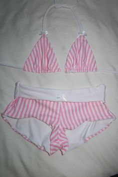 Your new favorite swim shorts are here.. <3 Low to mid rise fit white lining white bow detailing pink pinstripe pattern Styling & Fit Model wearing a size S Pair with the Candy Land Triangle Top for a complete look Fabric Nylon Spandex blend and lined Aftercare Hand wash in cold water and lay flat to dry Thank you for supporting my small business xx Caity Burdash Pink Pinstripe, Handmade Swimwear, Pinstripe Pattern, Swim Short, Swim Skirt, Summer Set, White Bow, Candy Land