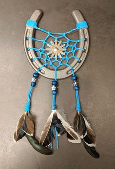 a blue and white dream catcher hanging on a wall