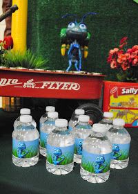 six bottled water bottles sitting on top of a table next to an assortment of toy figurines