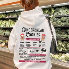 a person wearing a white hoodie with instructions for gingerbread cookies