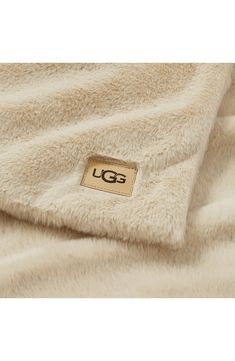 the lg logo is on top of a white fluffy blanket that's folded over