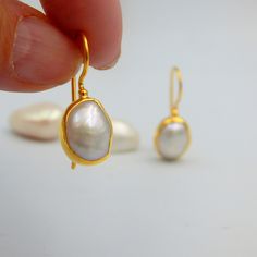 "White Fresh Water Baroque Pearl Drop Earrings. Sterling Silver 18k Gold Plated, 100% Handmade Unique Statement Earrings. PEARL: This enchanting June birthstone originates from oceans, lakes and rivers around the world. It is a timeless wardrobe staple, beloved by women of all ages. Pearls have long been associated with purity, humility and innocence. So it may be said that the June birthstone meaning is \"sweet simplicity.\" As such, pearls were traditionally given as a wedding gift. THE EARRIN Oval White Gold Pearl Earrings For Wedding, Handmade Yellow Gold Pearl Earrings For Wedding, Hallmarked Dangle Pearl Earrings For Wedding, Handmade Gold-plated Pearl Earrings For Wedding, Handmade Gold Plated Pearl Earrings For Wedding, Wedding Yellow Gold Oval Pearl Earrings, Teardrop Pearl Earrings For Wedding, Hallmarked, Gold Hallmarked Pearl Earrings For Wedding, Gold High Luster Earrings For Wedding