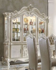 a dining room table with chairs and a china cabinet in the middle, along with other furniture